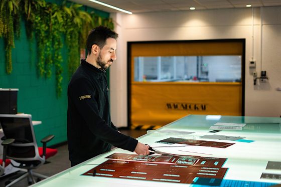 Magnegraf employee cutting imaged film