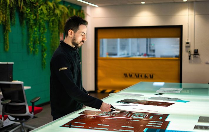 Magnegraf employee cutting imaged film